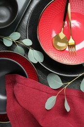 Photo of Flat lay composition with stylish ceramic plates and floral decor on grey table