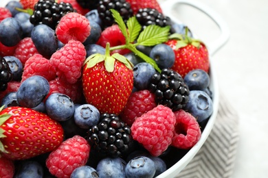 Photo of Mix of ripe berries in bowl, closeup