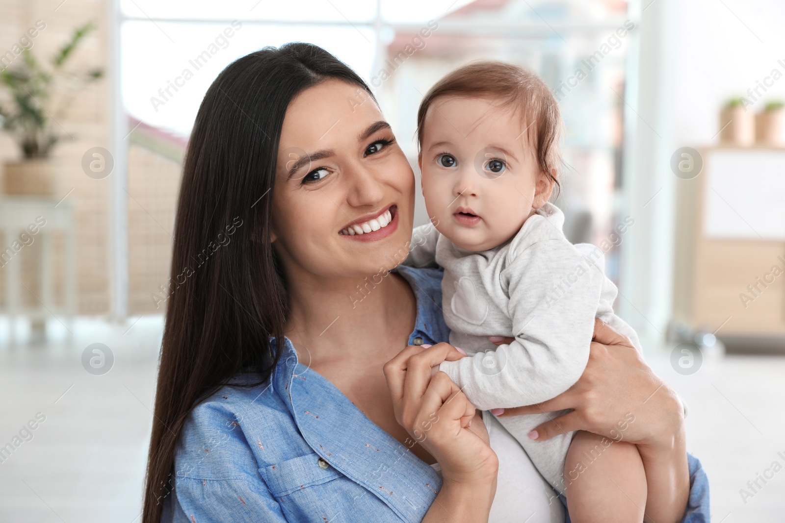 Photo of Portrait of young mother and her adorable baby at home