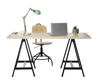 Photo of Stylish workplace with wooden desk and comfortable chair on white background