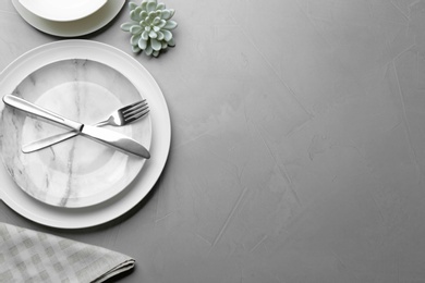 Photo of Elegant table setting on grey background, flat lay. Space for text