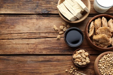 Photo of Different natural soy products on wooden table, flat lay. Space for text