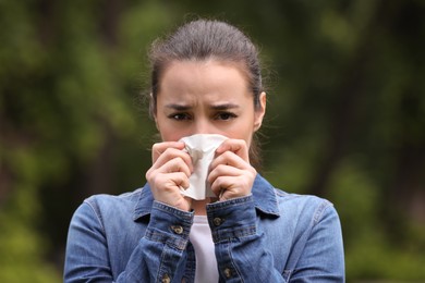 Photo of Woman suffering from seasonal spring allergy outdoors