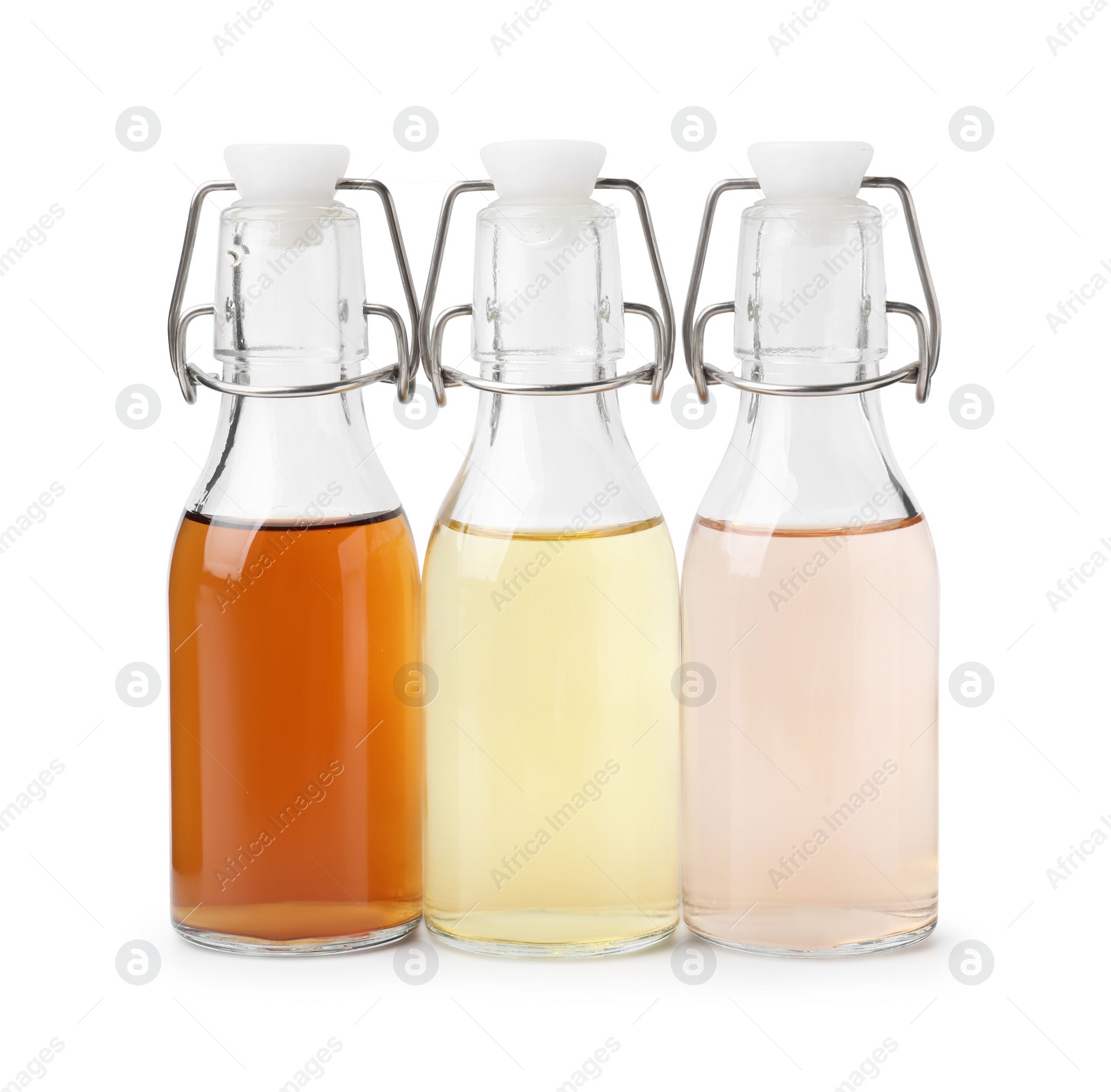 Photo of Different types of vinegar in bottles isolated on white