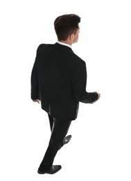Businessman in formal suit on white background, back view