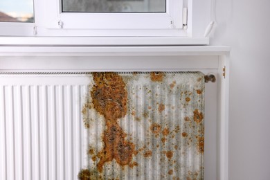 Modern panel radiator affected by rust indoors
