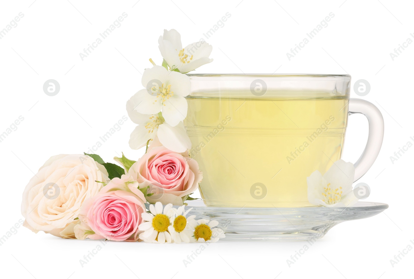 Photo of Aromatic herbal tea in glass cup and flowers isolated on white