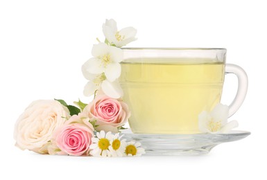 Photo of Aromatic herbal tea in glass cup and flowers isolated on white