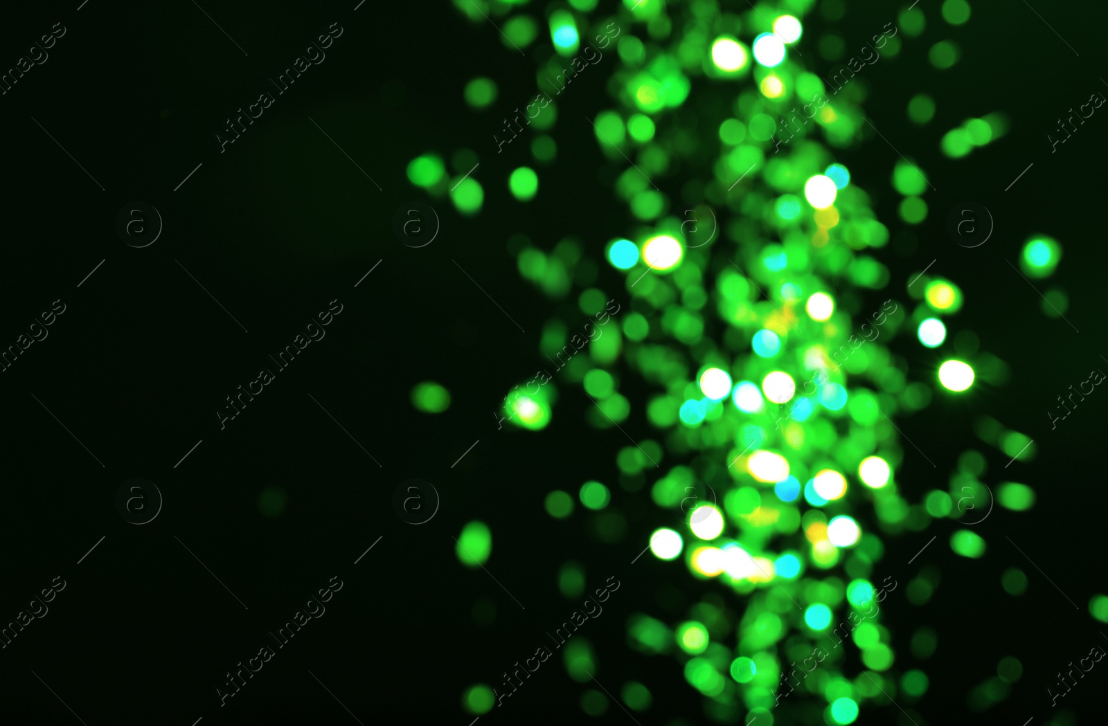 Image of St. Patrick day. Black background with blurred green lights, bokeh effect