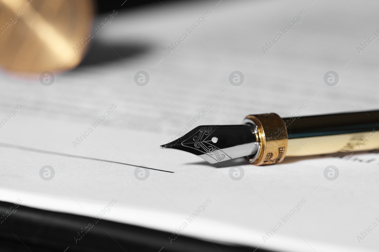 Photo of Fountain pen and paper document on table, closeup with space for text. Notary service