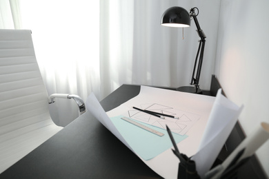Stylish workplace with modern lamp and stationery