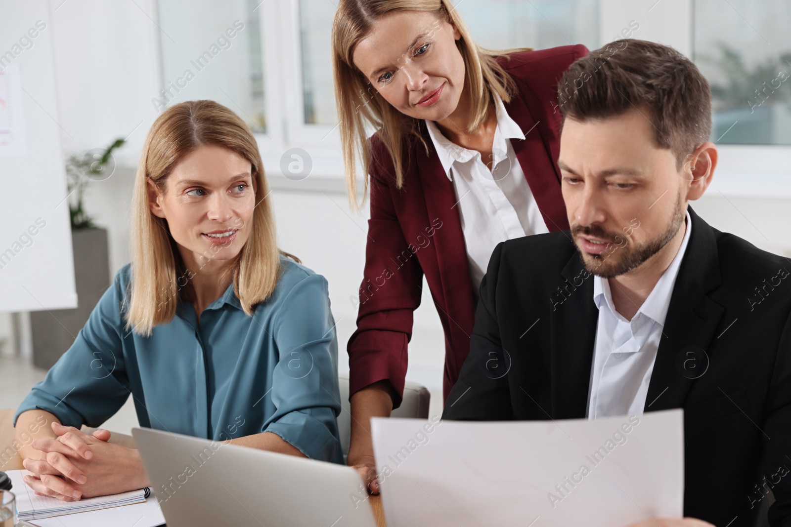 Photo of Businesswoman having meeting with her employees in office