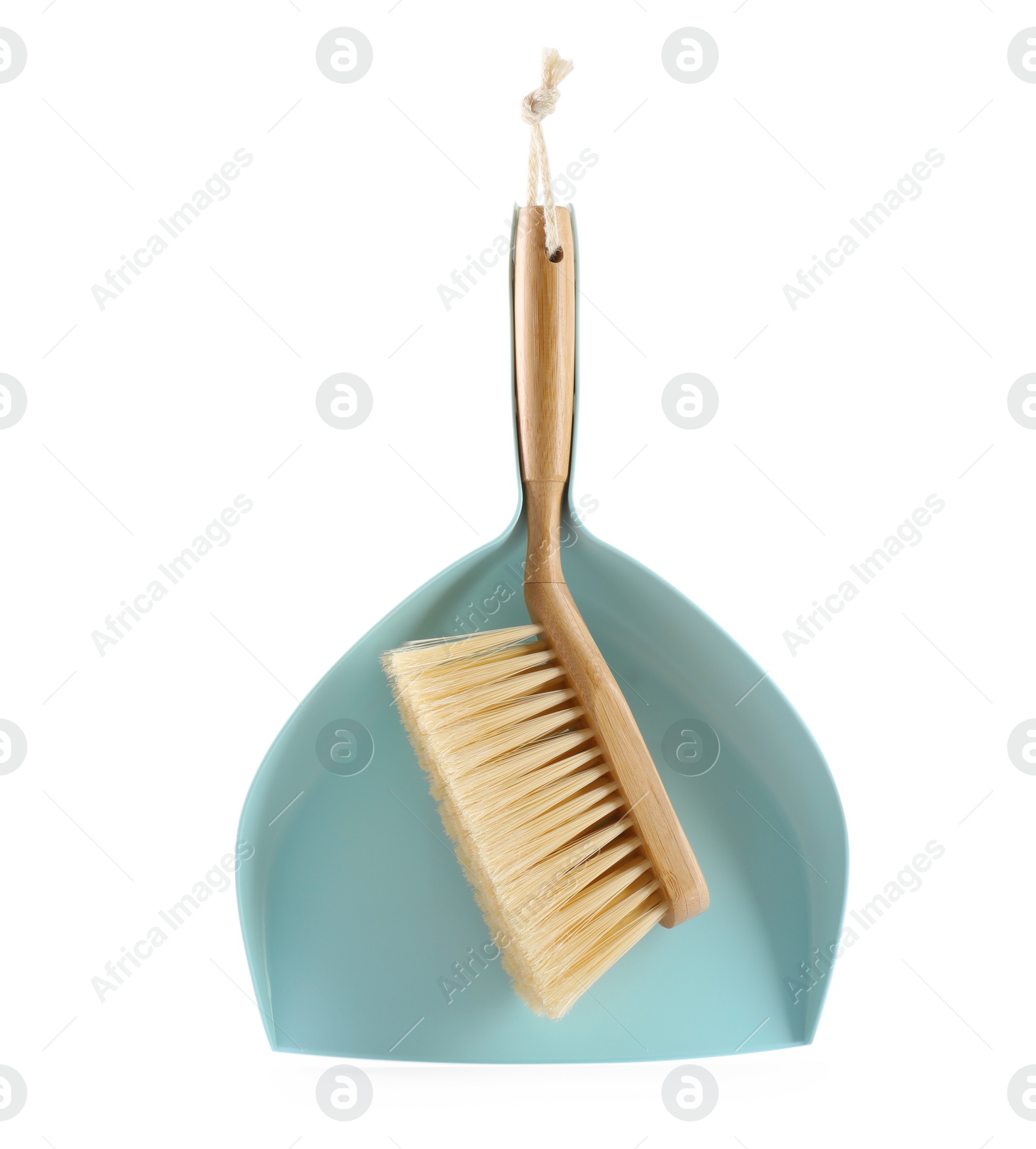 Photo of Light blue dustpan and wooden brush on white background