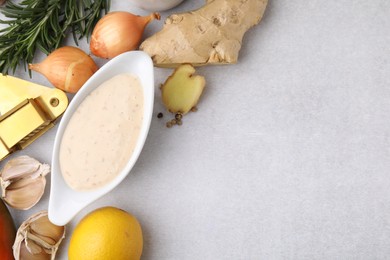 Photo of Fresh marinade and different ingredients on light grey table, flat lay. Space for text