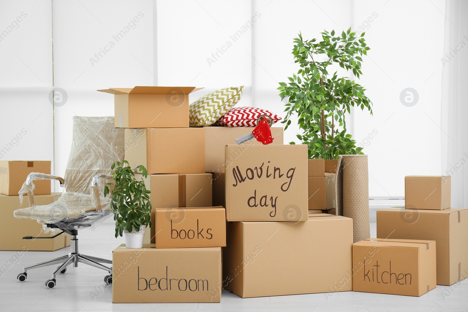 Photo of Pile of moving boxes in empty room