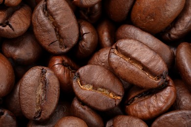 Aromatic roasted coffee beans as background, top view