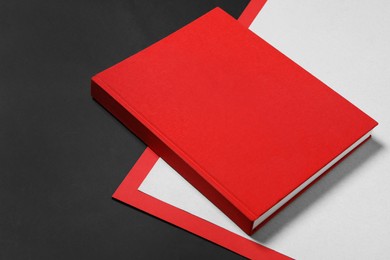 Photo of Book with red cover on color background. Space for text