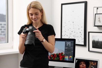 Photo of Professional photographer with modern digital camera in office