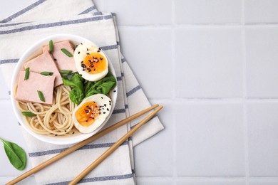 Photo of Delicious ramen with meat on white tiled table, flat lay and space for text. Noodle soup