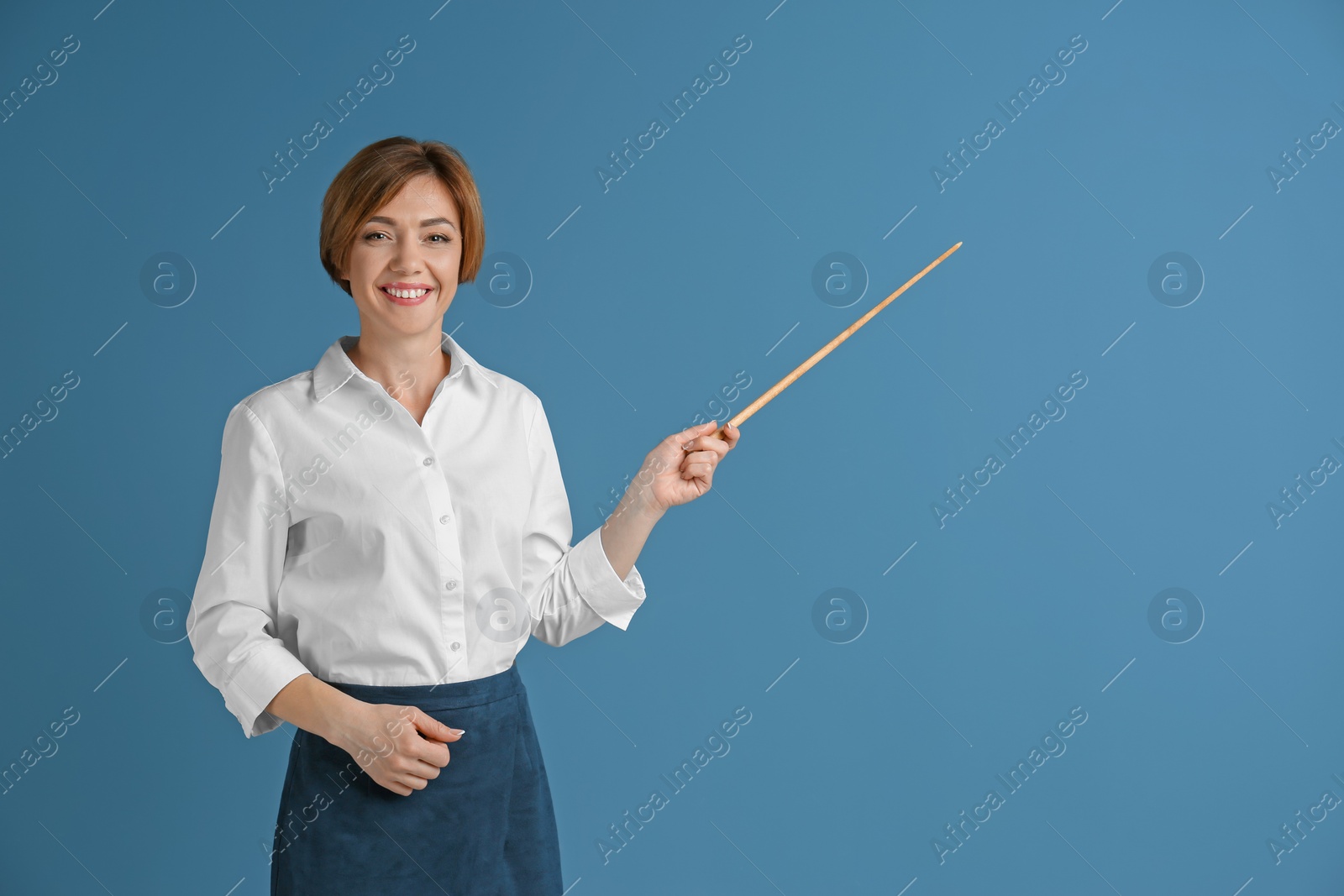 Photo of Portrait of female teacher with pointer on color background