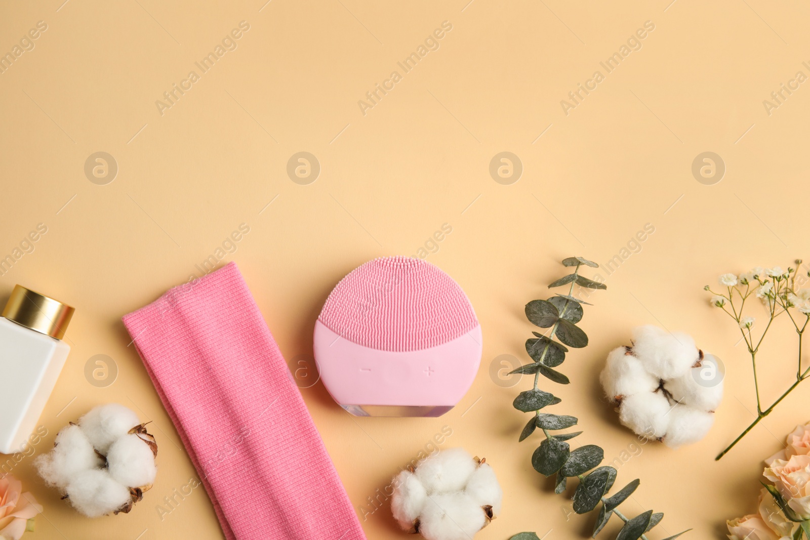 Photo of Flat lay composition with face cleansing brush on beige background. Cosmetic accessory