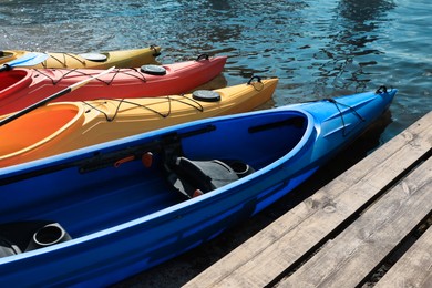 Photo of Modern kayaks with paddles on river. Summer camp activity