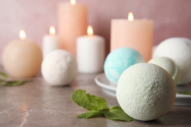 Photo of Bath bombs and mint leaves on table. Space for text