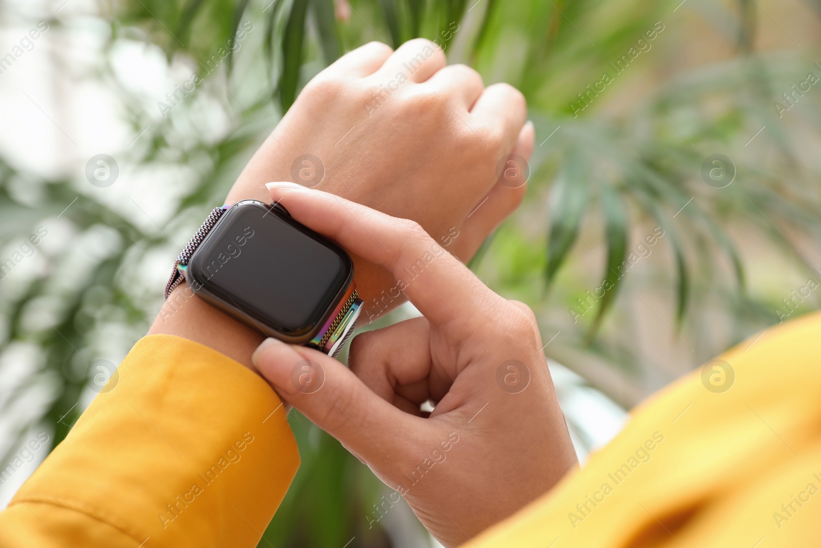 Image of Woman checking stylish smart watch at home, closeup