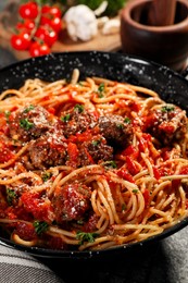 Photo of Delicious pasta with meatballs and tomato sauce on frying pan, closeup
