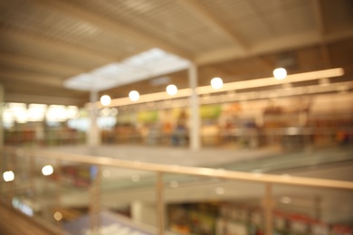 Photo of Blurred view of modern shopping mall interior