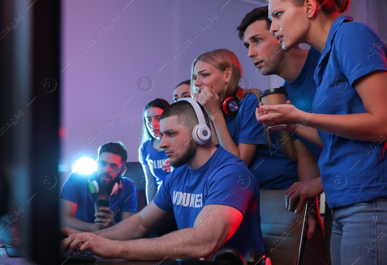 Photo of Young people playing video games on computers indoors. Esports tournament