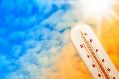 Image of Weather thermometer with high temperature and color sky on background, space for text 