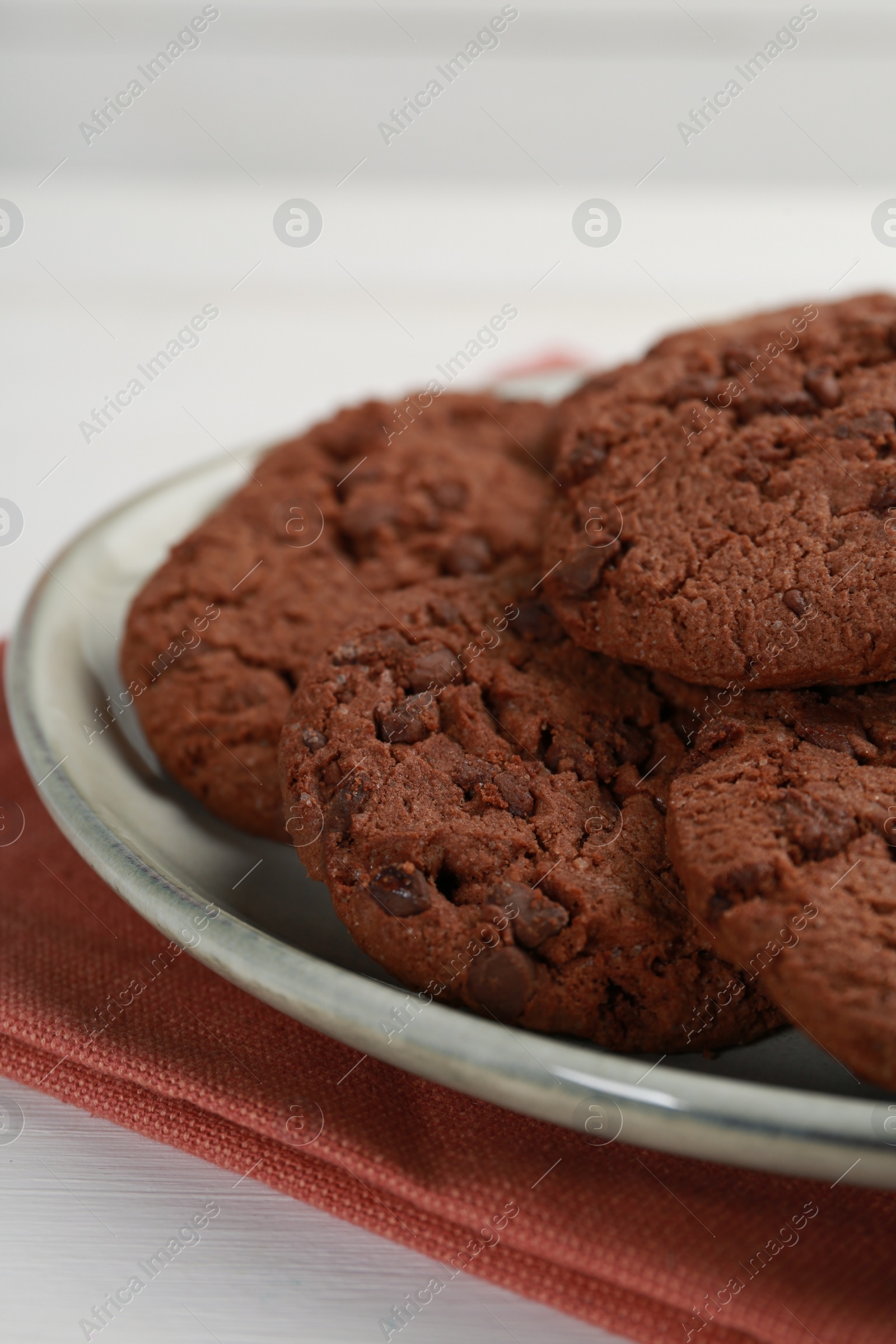 Photo of Delicious chocolate chip cookies on white table, closeup