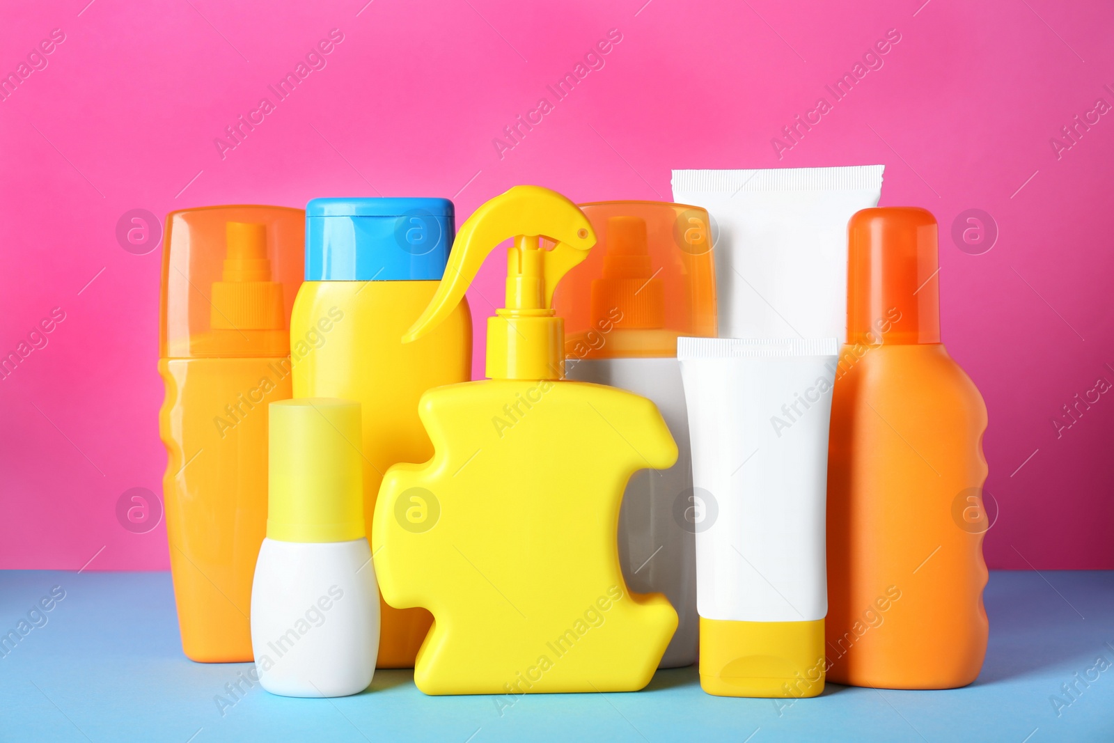 Photo of Many different suntan products on color background