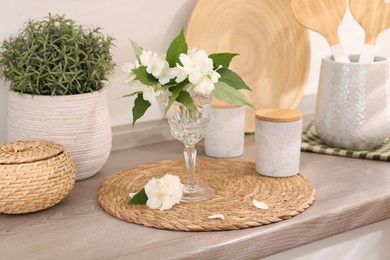 Photo of Beautiful jasmine flowers on wooden table indoors