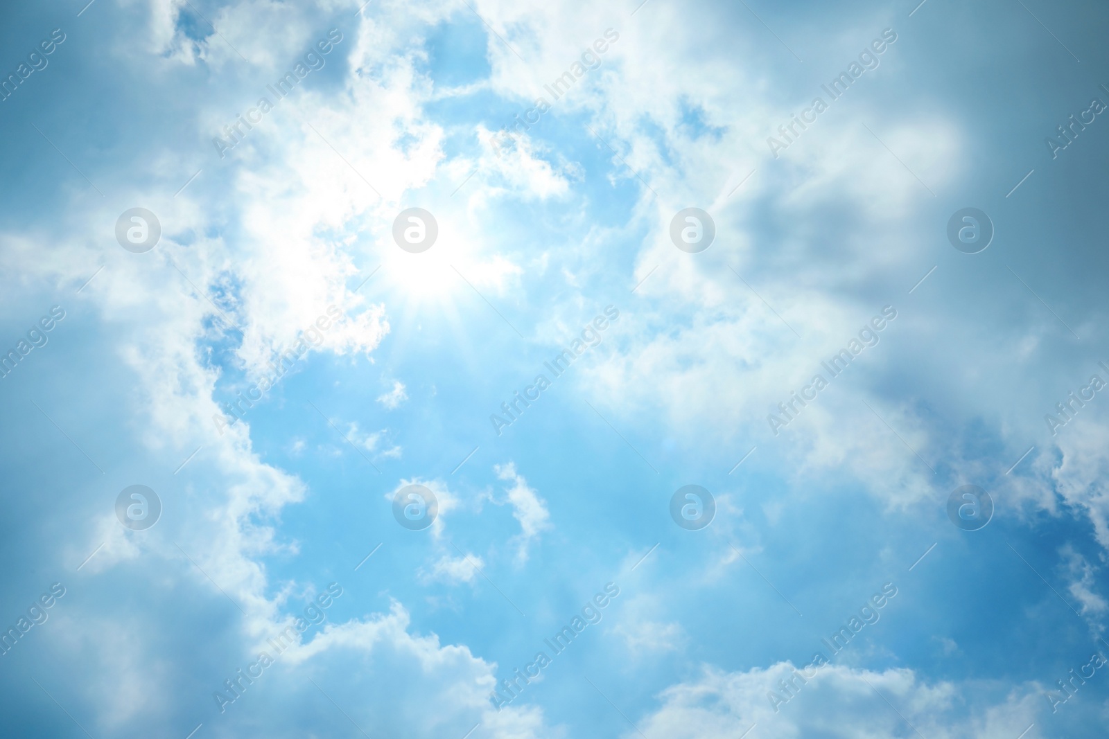 Photo of View of beautiful blue sky with fluffy clouds and sunbeams