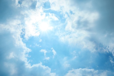 Photo of View of beautiful blue sky with fluffy clouds and sunbeams