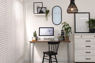 Cozy workspace with computer on wooden desk at home