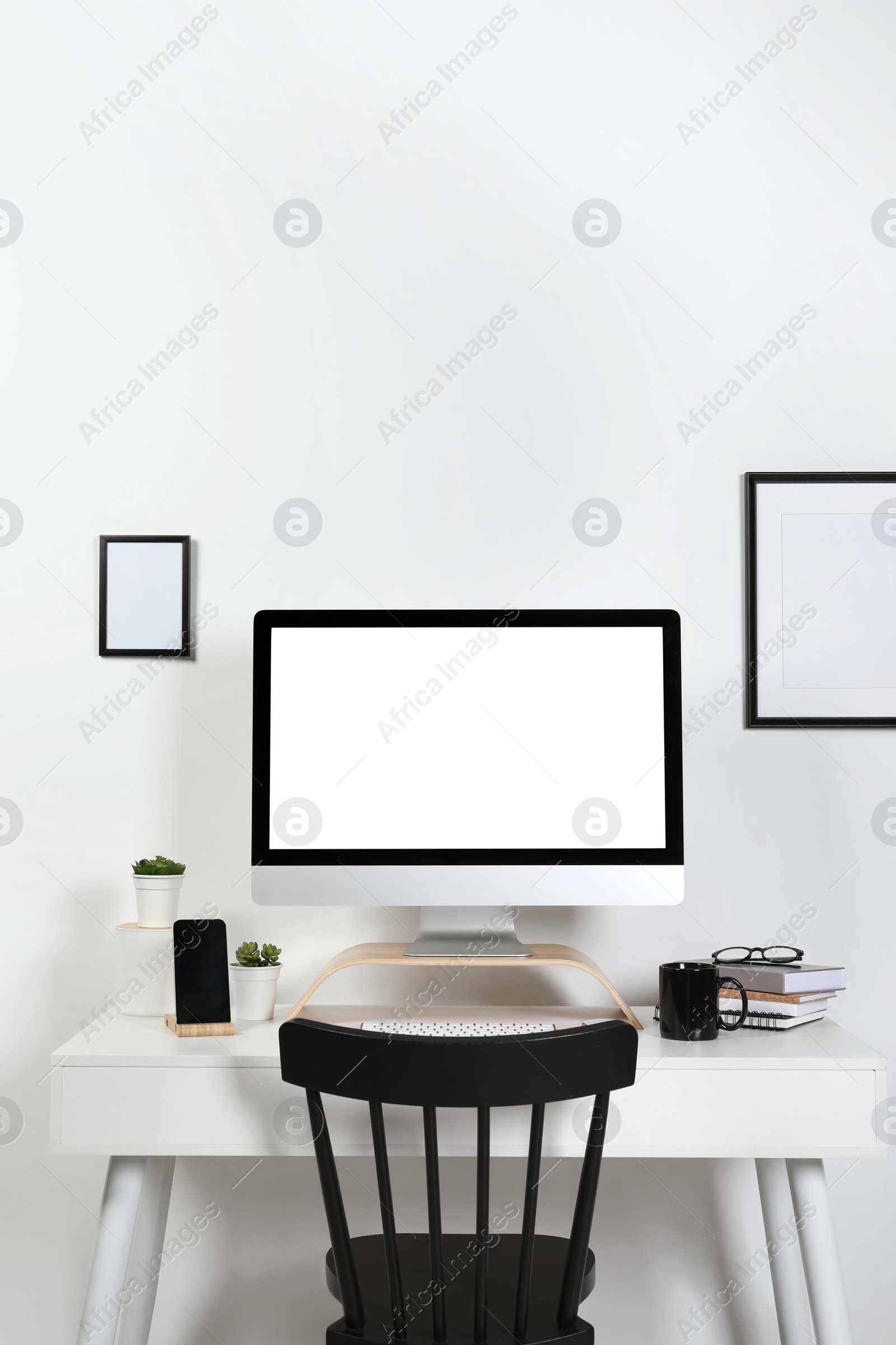 Photo of Cozy workspace with computer, smartphone and stationery on wooden desk at home