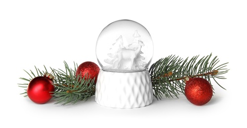 Photo of Magical snow globe with pine branches and Christmas balls on white background