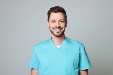 Photo of Doctor or medical assistant (male nurse) in uniform on light grey background