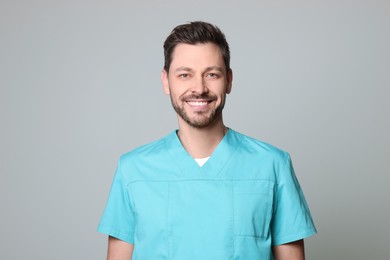 Doctor or medical assistant (male nurse) in uniform on light grey background