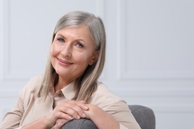 Photo of Portrait of beautiful senior woman indoors. Space for text