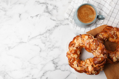 Photo of Delicious pastries and coffee on marble table, flat lay. Space for text