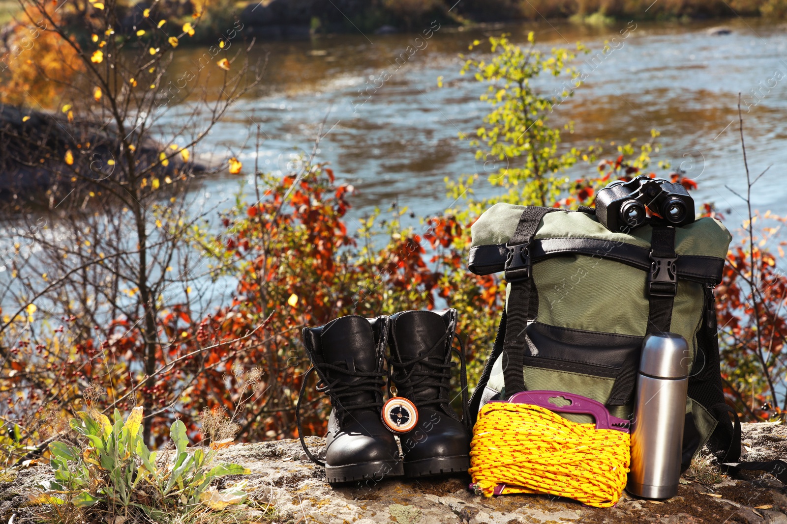 Photo of Set of camping equipment on ground outdoors. Space for text