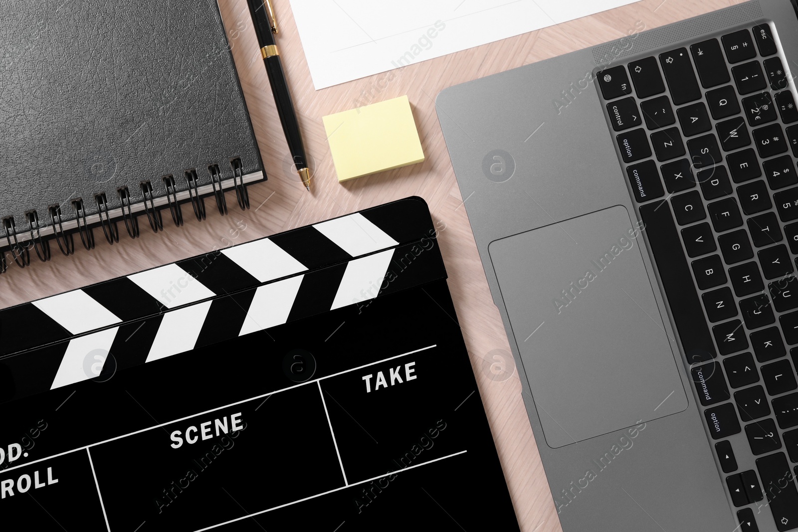 Photo of Flat lay composition with movie clapper on wooden table