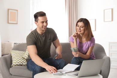 Couple managing budget to save money in living room