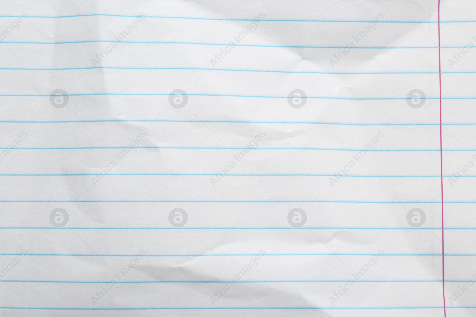 Photo of Crumpled lined notebook sheet as background, top view