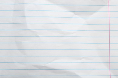 Crumpled lined notebook sheet as background, top view