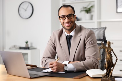 Portrait of smiling lawyer at table in office